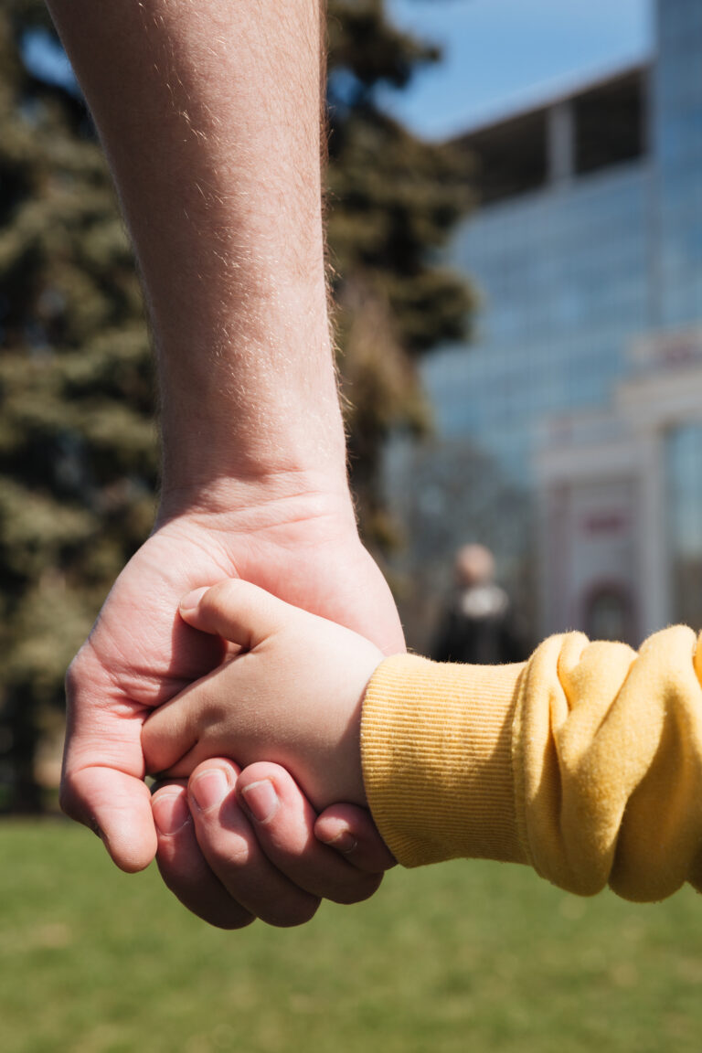 Father and son holding hands