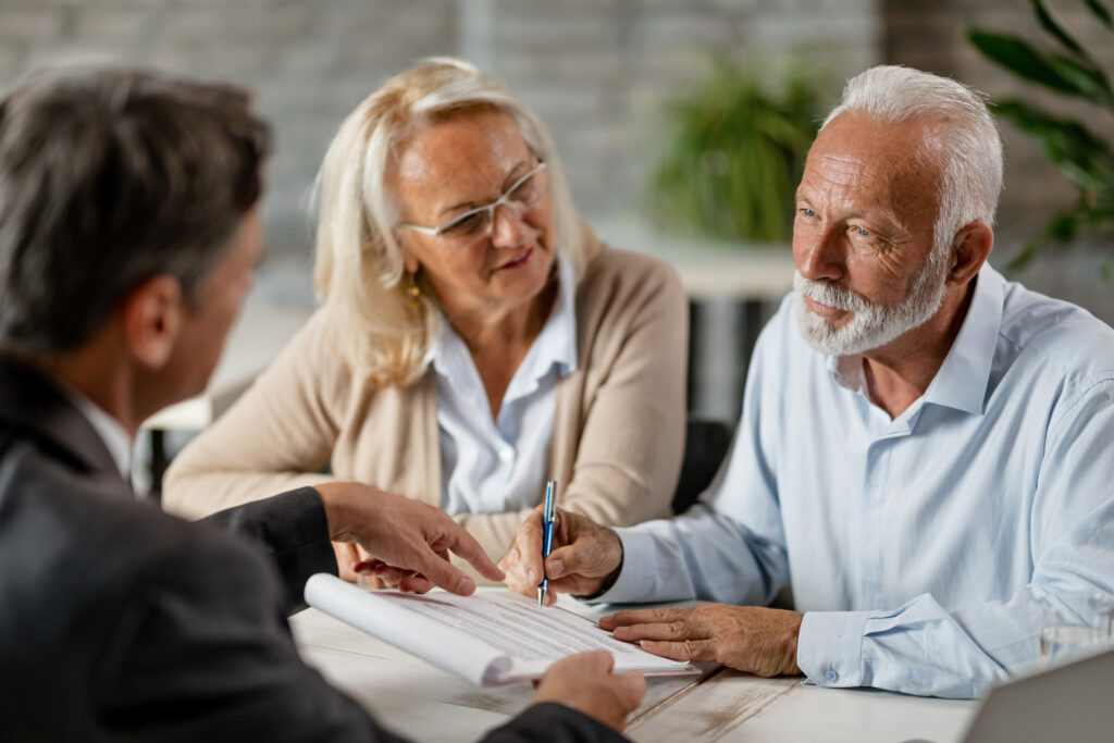 Elderly couple signing